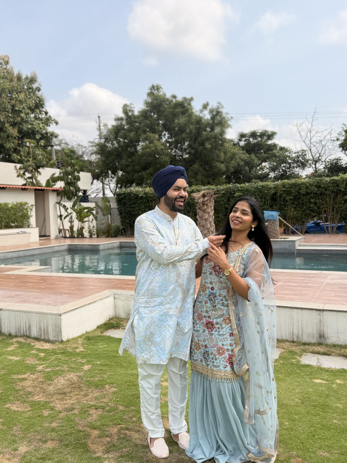Ashrita and Gursimran laughing by the pool