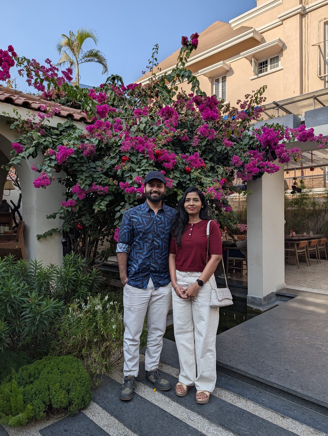 Ashrita and Gursimran under bougainvillea